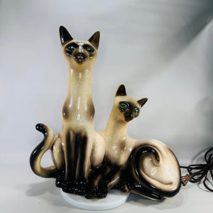 Vintage Lane & Co Siamese cats ceramic lamp with glossy cream and brown glaze, teal-green jewel eyes, and sculptural mid-century design.