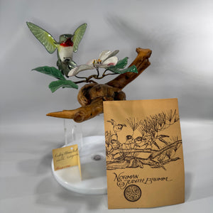 Norman and Judith Brumm ruby-throated hummingbird enamel-on-copper sculpture hovering over dogwood blossom on a natural burl wood base, signed.sculpture hovering over dogwood blossom on a natural burl wood base, signed.