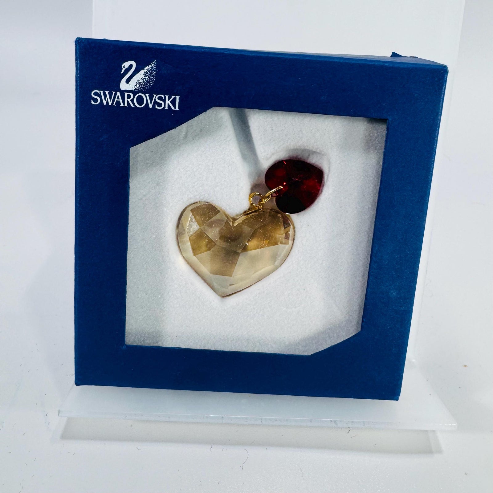 Swarovski Festive Hearts ornament in original blue box—faceted champagne Golden Shadow heart with small red Light Siam heart accent.