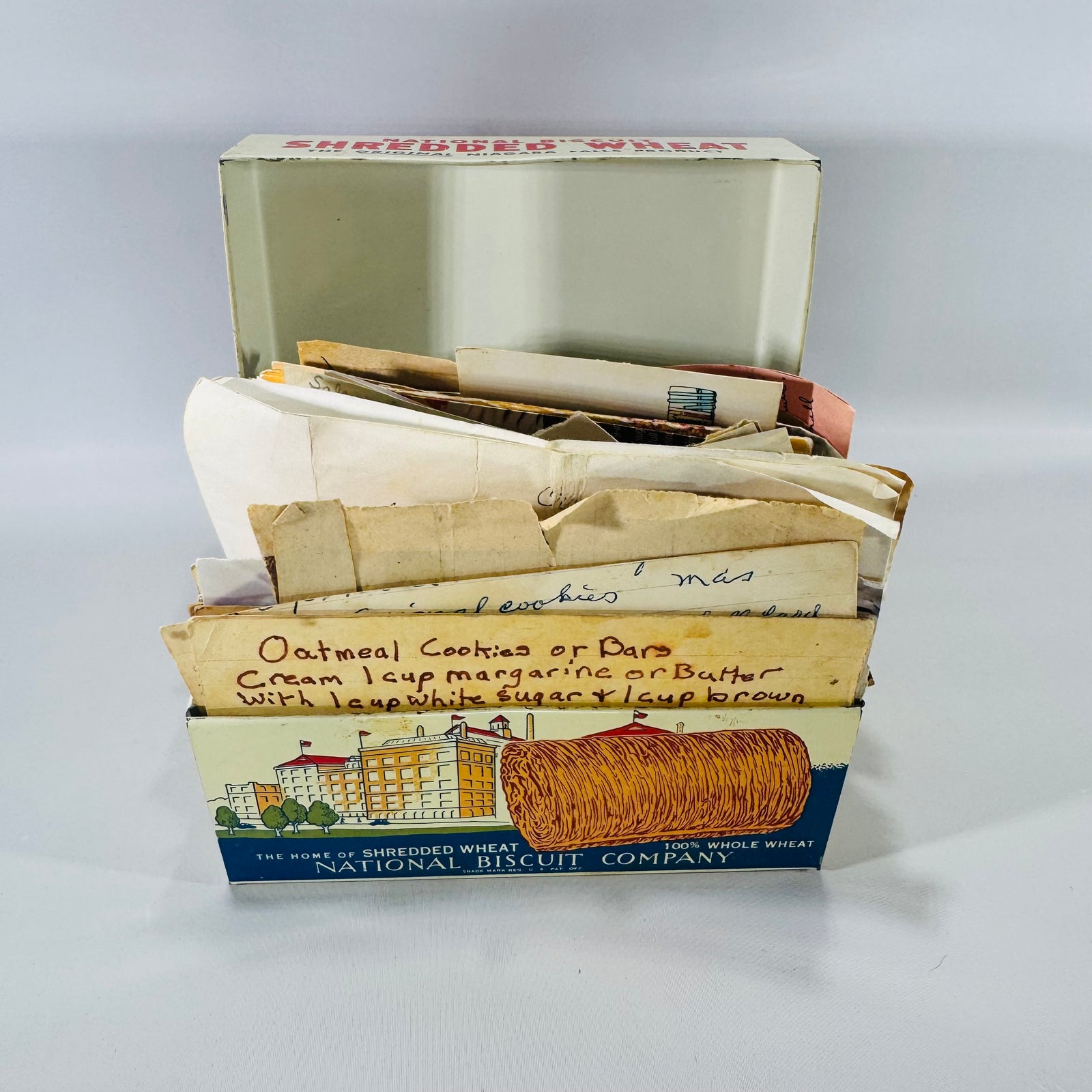 Vintage Nabisco Shredded Wheat “Recipes” box dated 1973 filled with handwritten recipe cards and newspaper clippings, estate kitchen ephemera lot.