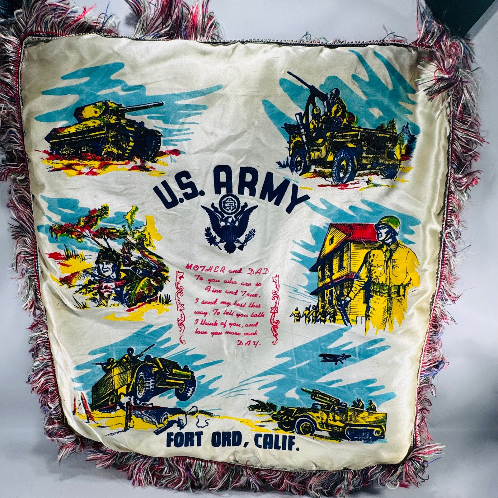 Vintage U.S. Army Fort Ord Calif souvenir satin sweetheart pillow cover with multicolor fringe and military scene graphics, “U.S. ARMY” and “FORT ORD, CALIF.”