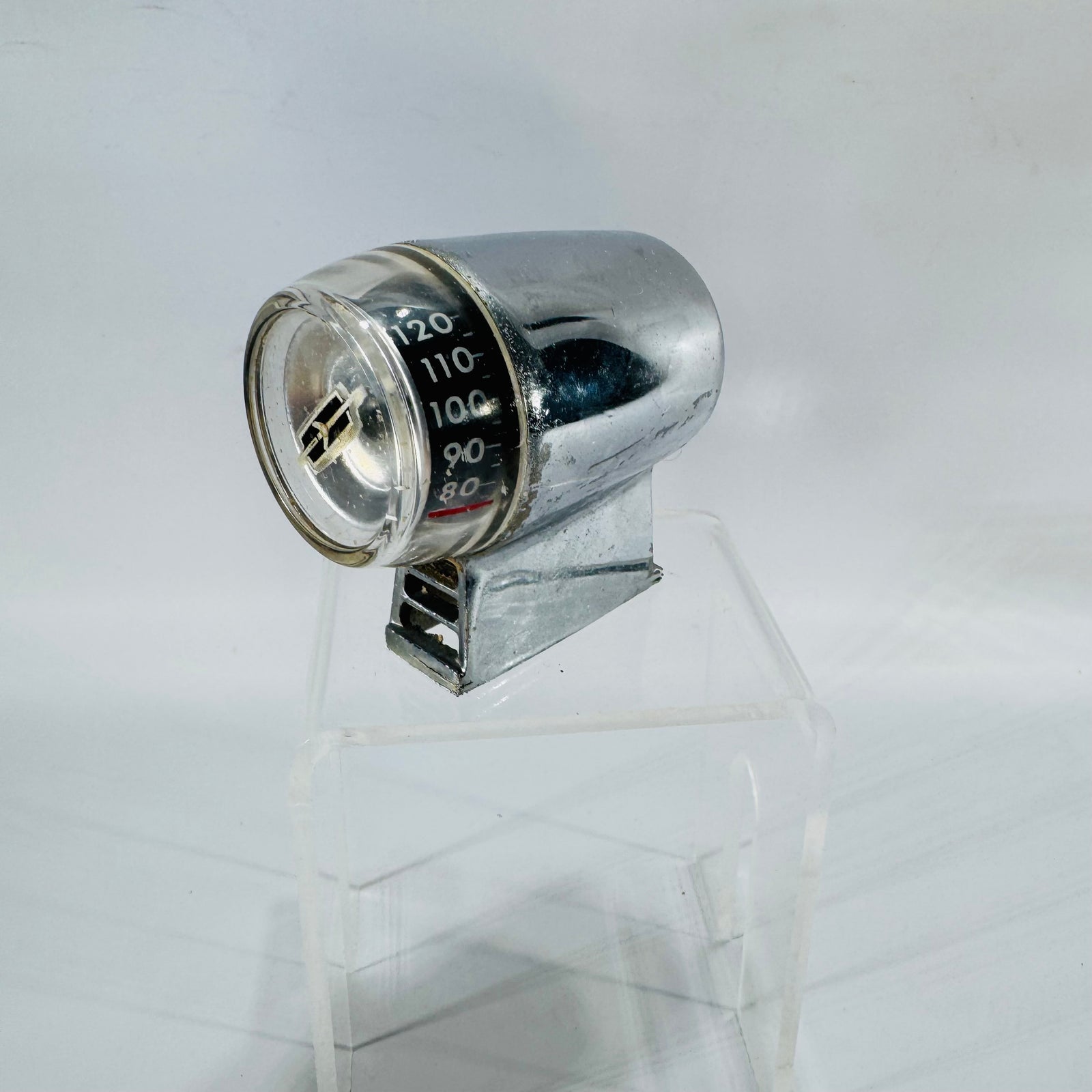 Vintage chrome Oldsmobile outside door thermometer gauge with black dial and clear lens, drum-style accessory part.