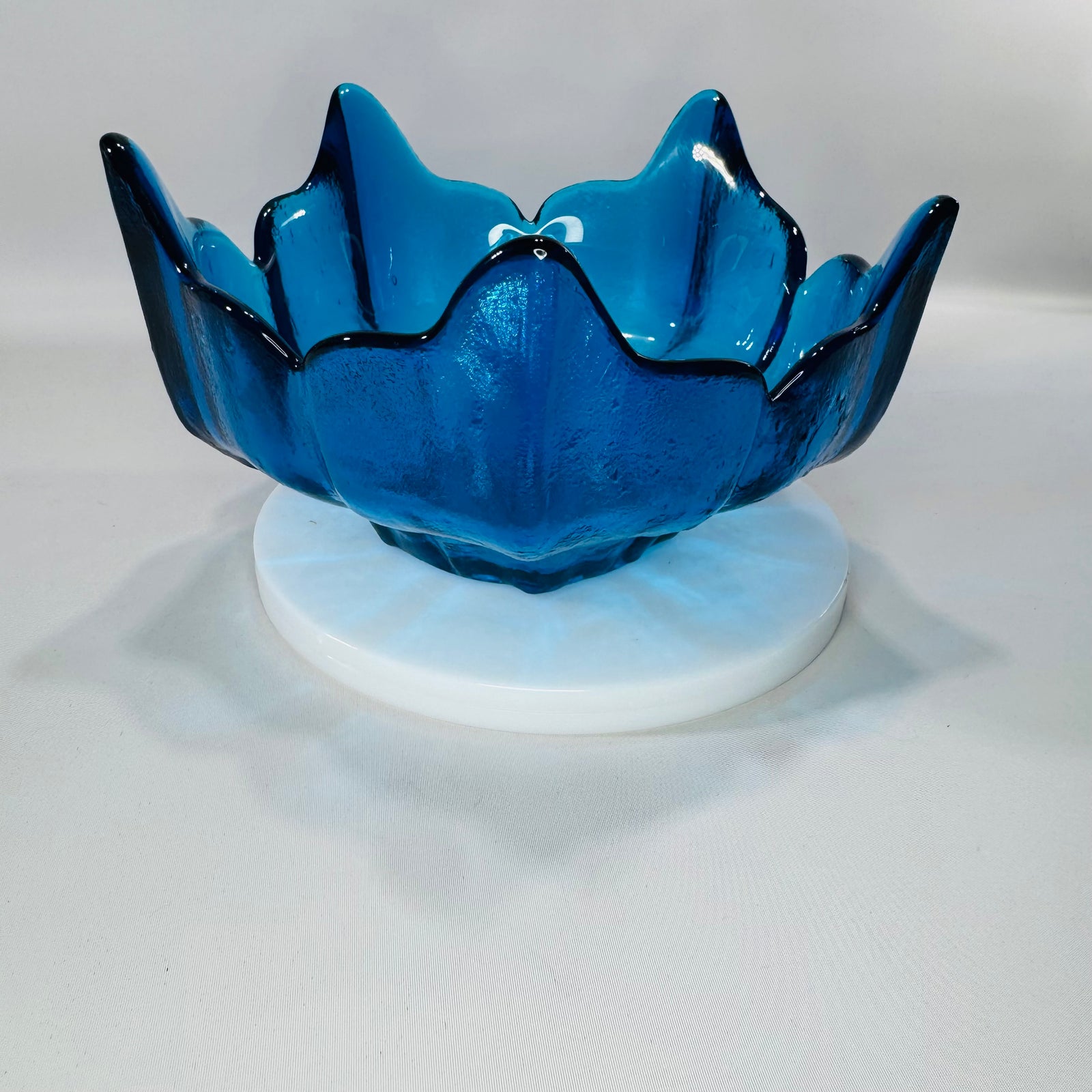 Vintage cobalt blue Viking glass lotus petal bowl with five-point flower rim and textured finish, photographed on a white background.