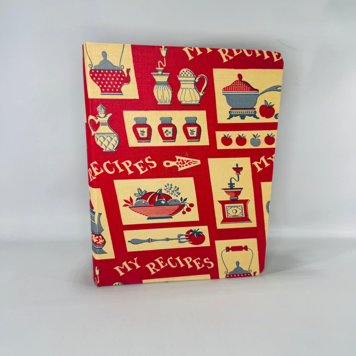 Vintage red “My Recipes” fabric-covered 3-ring recipe binder with kitchen motif print, tab dividers and lined pages, shown open with envelopes and recipe papers.