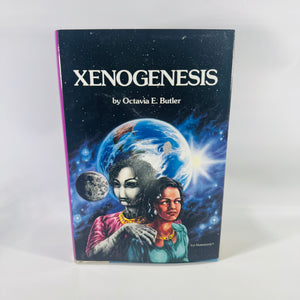  Xenogenesis by Octavia E. Butler—vintage science fiction hardcover with black starry jacket, purple spine, and illustrated Earth-and-figures artwork.