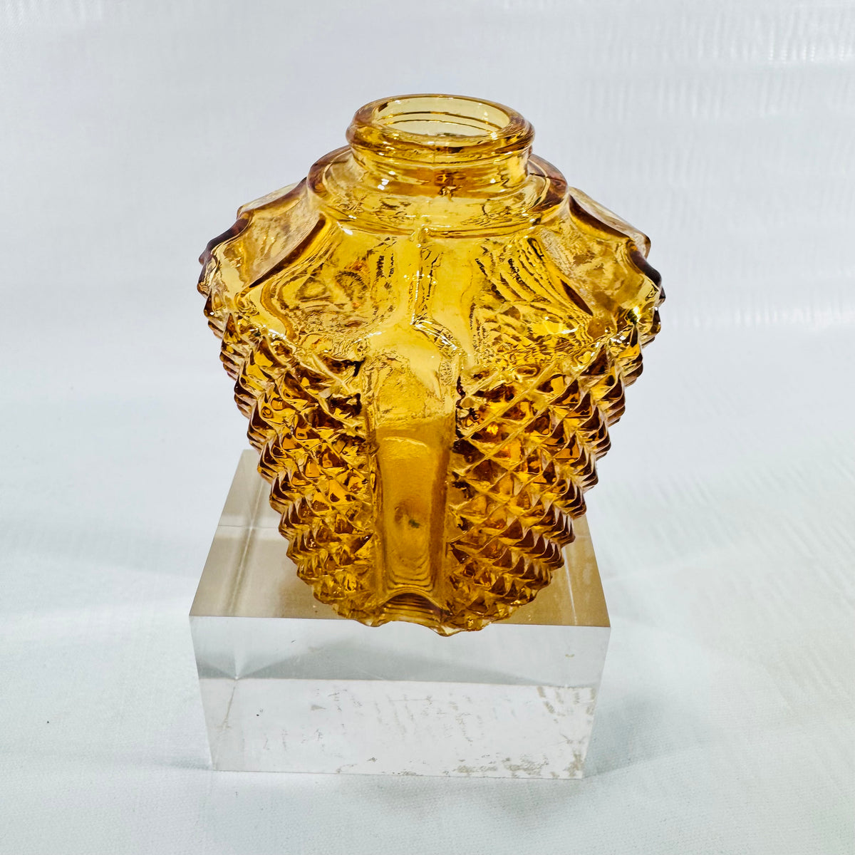 Side view of a small amber diamond point glass light shade