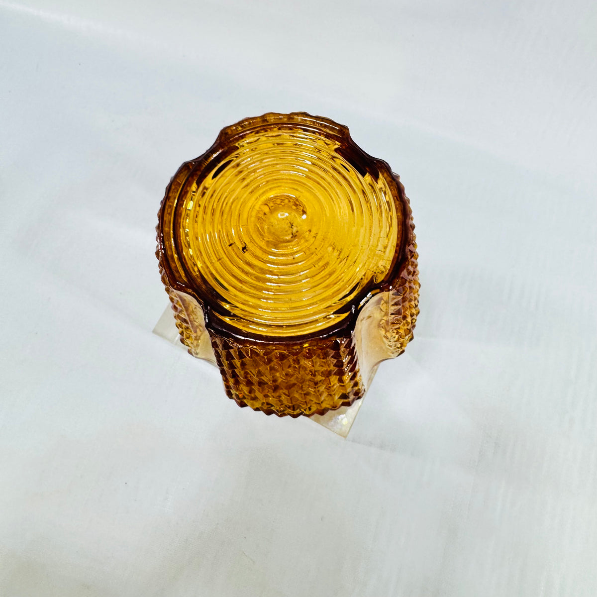 Top of an amber glass light shade with concentric ring pattern