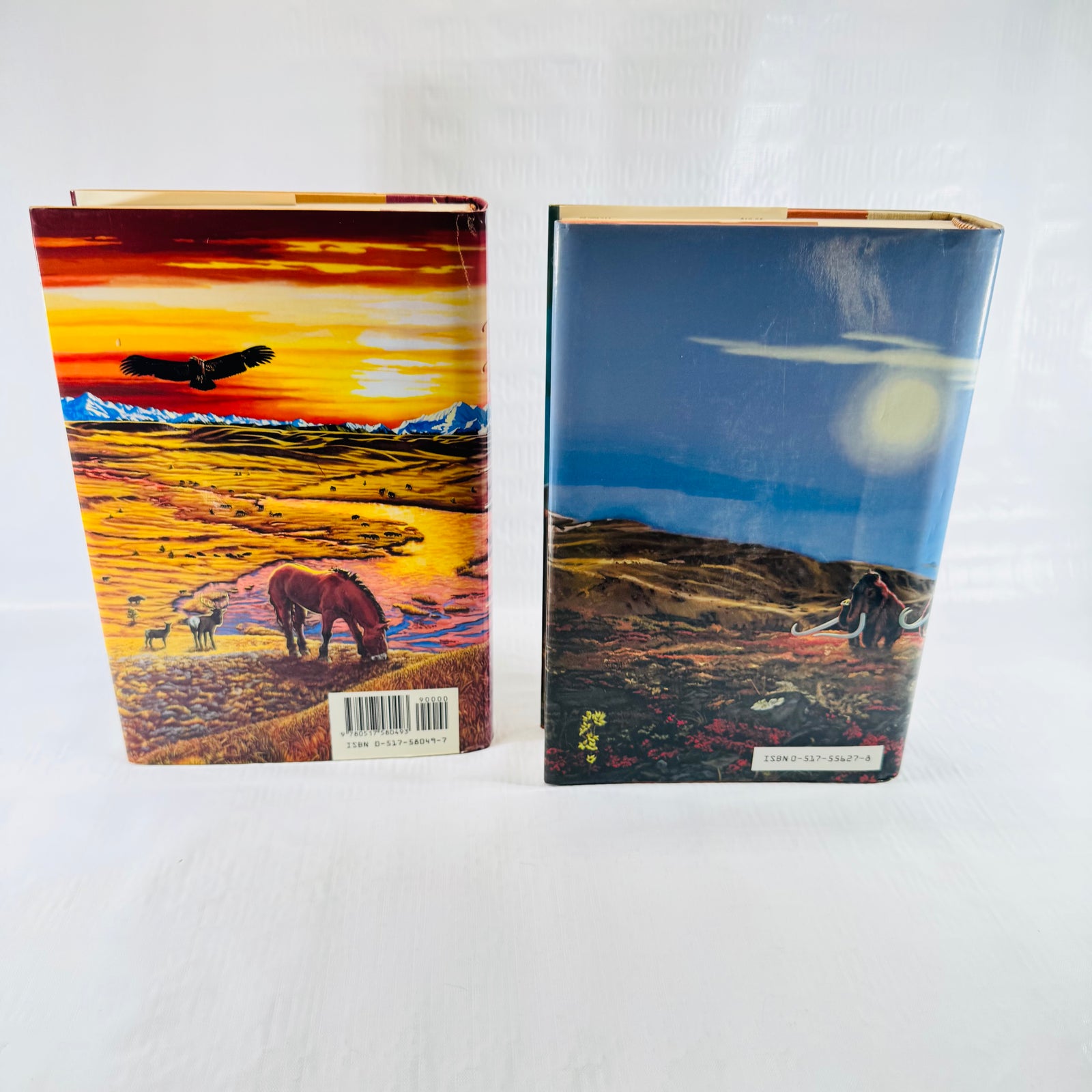 Back covers of both jackets, one with a mammoth under the moon