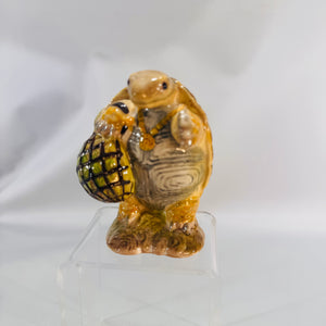 Beswick Beatrix Potter Mr. Alderman Ptolemy Tortoise, 3.5-inch glazed earthenware figure holding a netted bag, brown and green tones—front view.