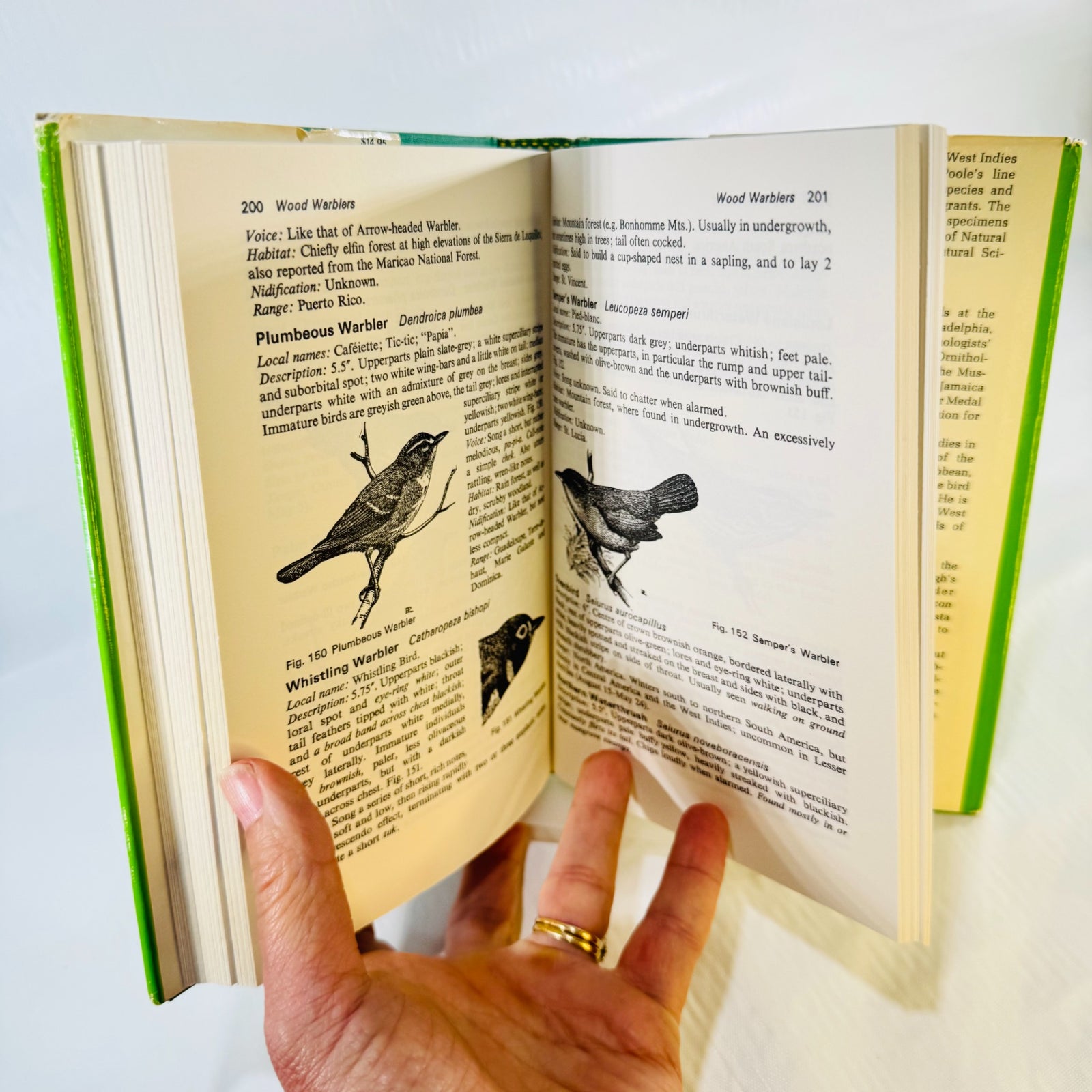 Birds of the West Indies open to pages 200 and 201, with wood warbler descriptions and black-and-white bird drawings.