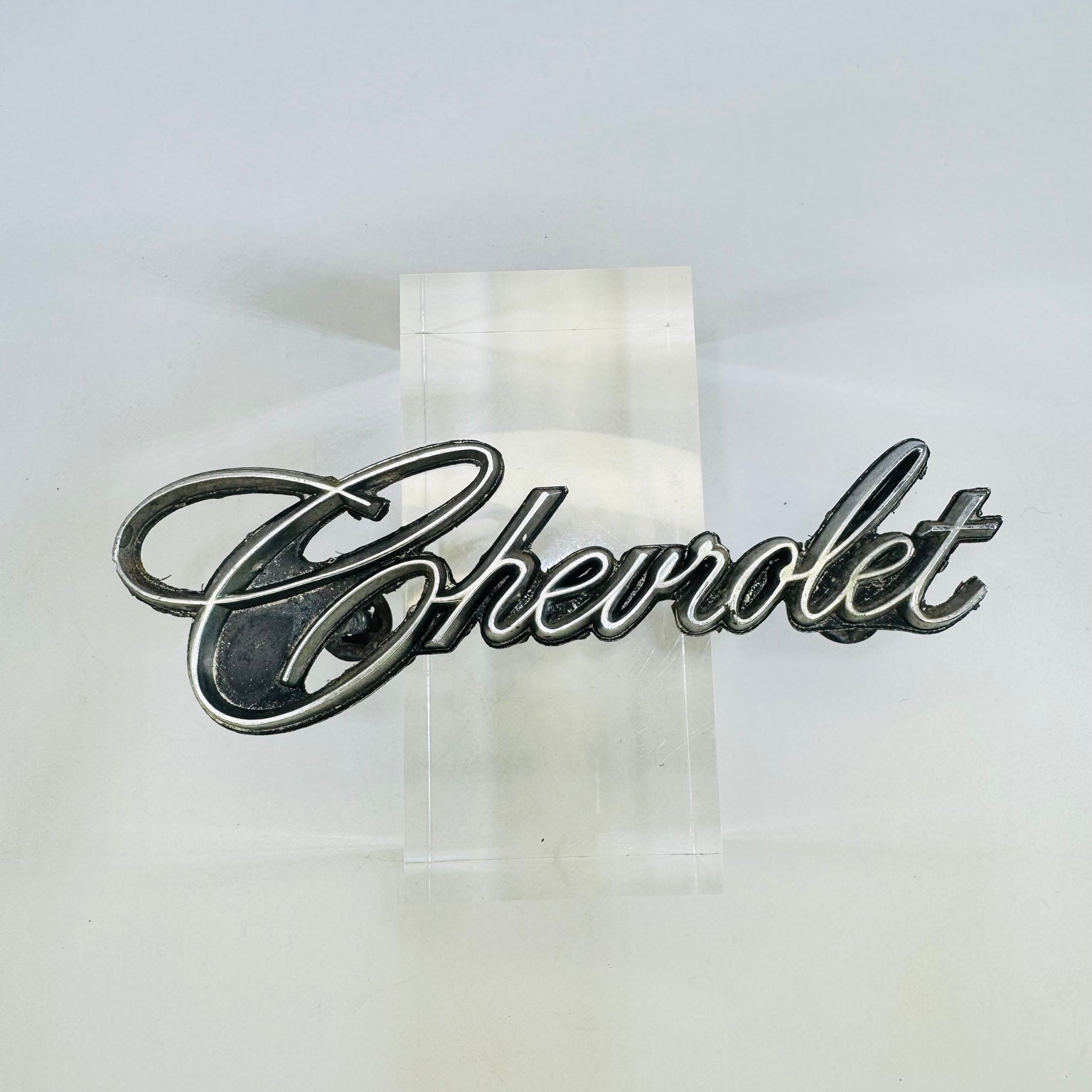 Original Chevrolet 342389 script grille emblem front view