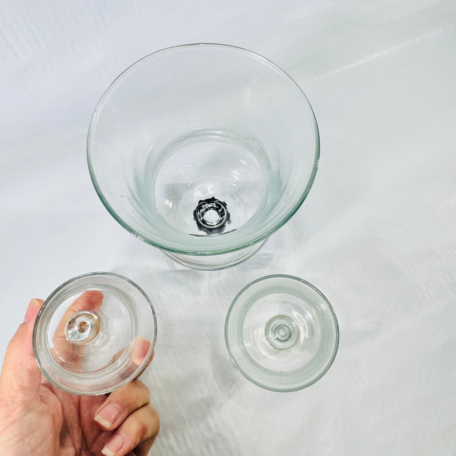 All three peg votive cups upside down, showing the tan gripper, black gripper, and bare peg.
