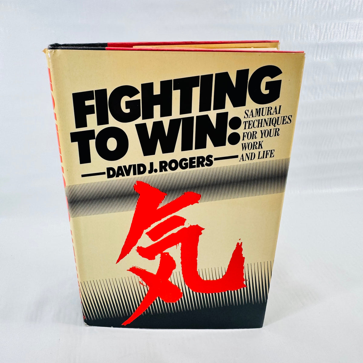Front dust jacket of Fighting to Win by David J. Rogers, 1984 Doubleday hardcover, with a red ki character on cream.