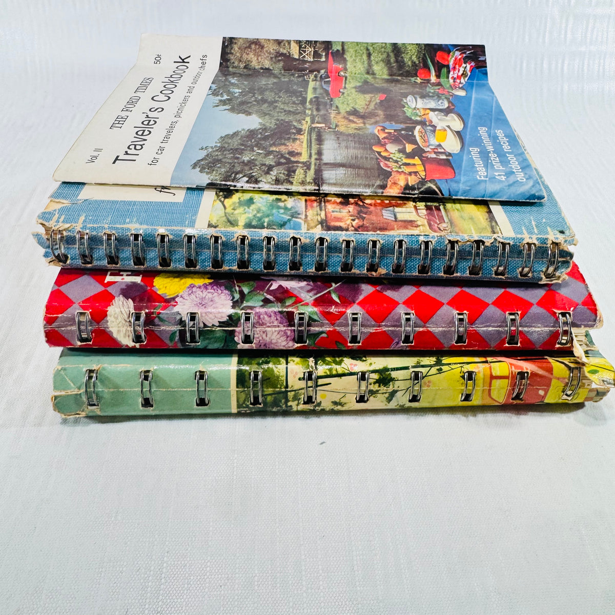 Stack of all four cookbooks with the Traveler's Cookbook on top
