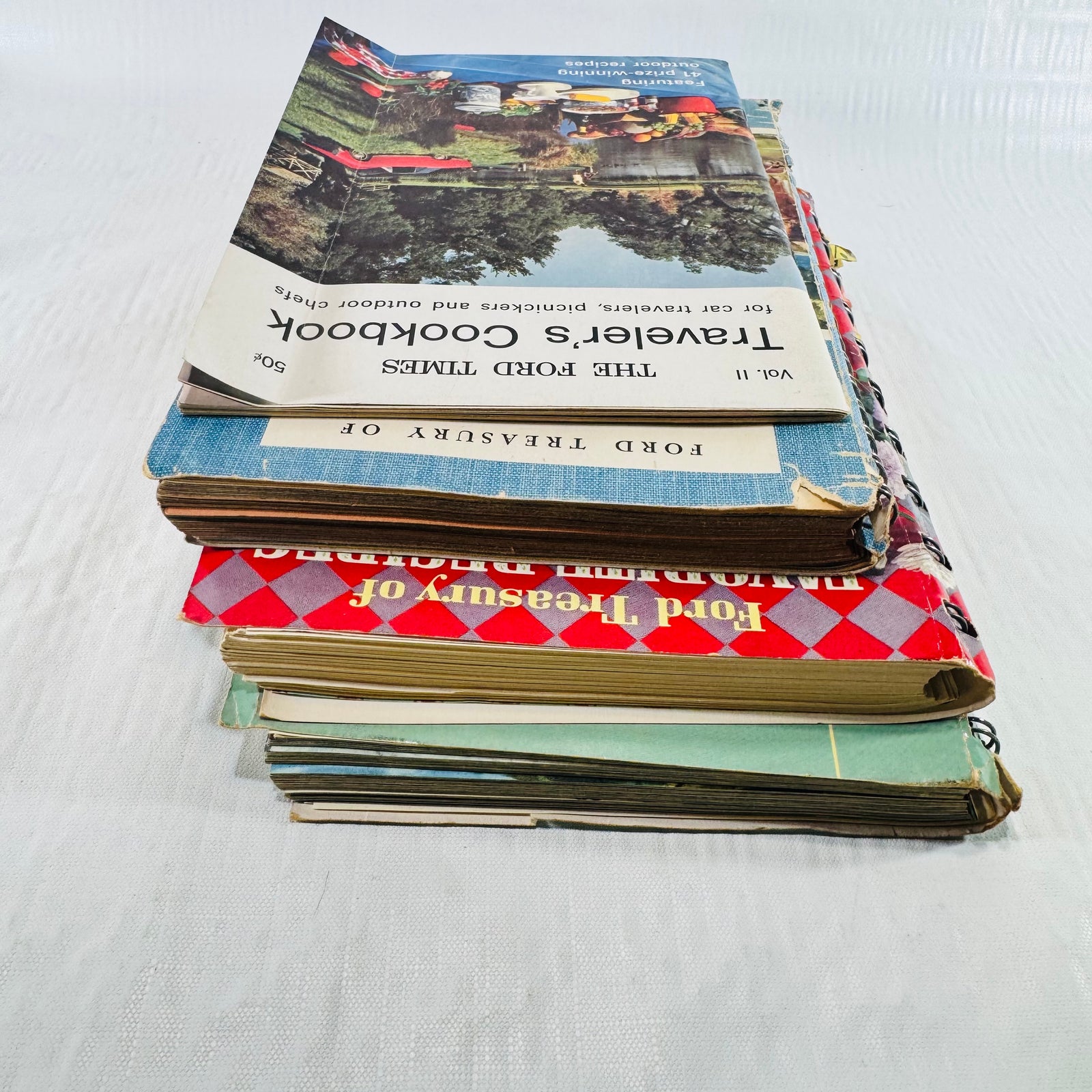 Wider view of the four book stack with spiral spines at right