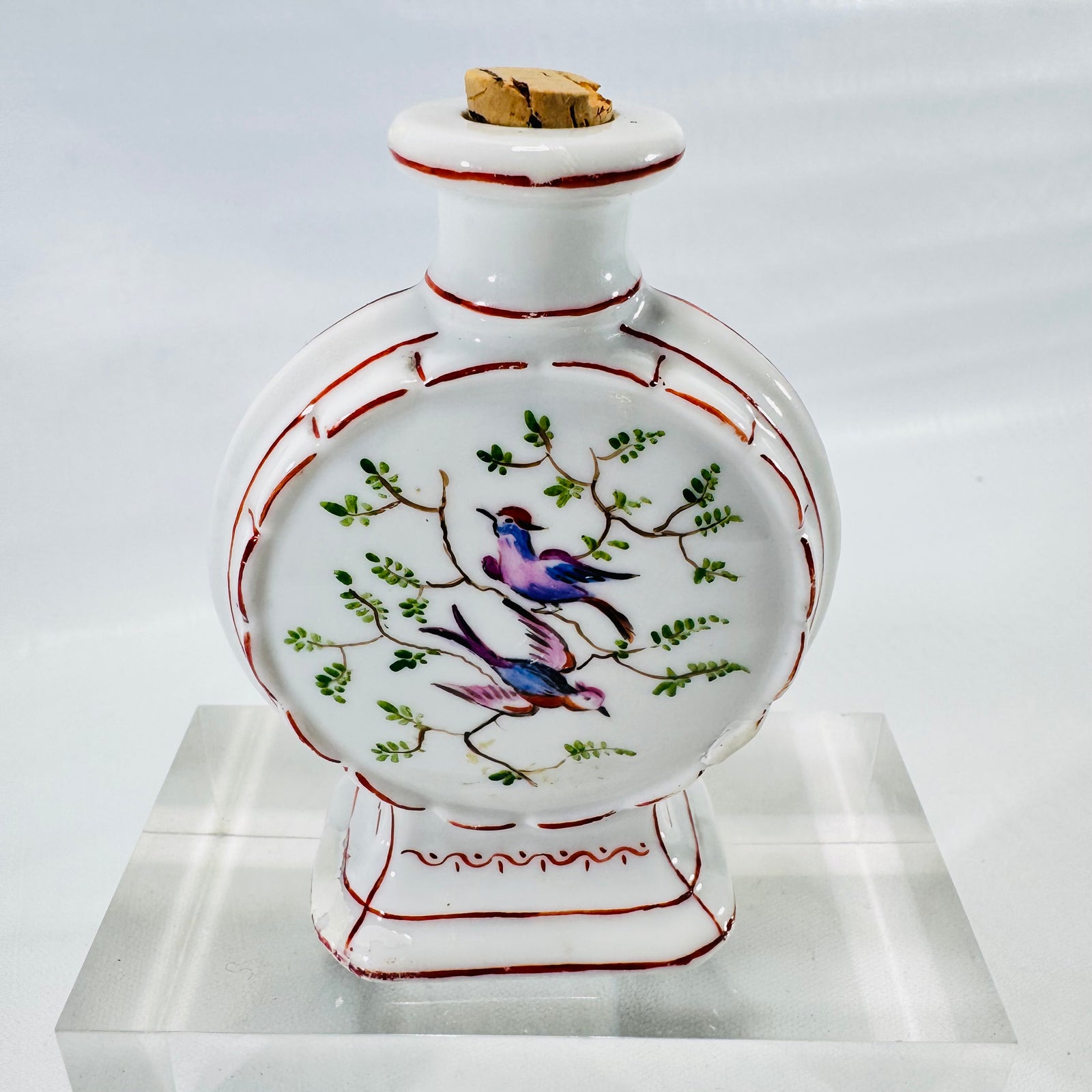 Back of the porcelain moon flask bottle with a second painted panel of two birds on branches.