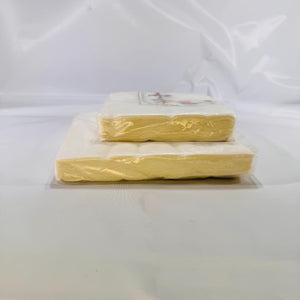 Angled view of both silver‐wrapped napkin packs showing vintage packaging and condition