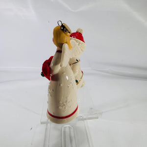 Rear and side view of Lenox® Christmas ornaments: the 4″ angel with white wings and a gold halo, and the 4″ teddy bear with Christmas lights and a red Santa hat, showing fine porcelain detailing and gold trim.