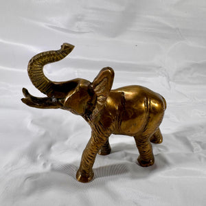 Right side view of brass elephant figurine displaying trunk position and detailed ear and leg features.