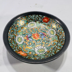 Angled close-up of the interior rim of the cloisonné bowl, highlighting gold outlining on floral enamel work.