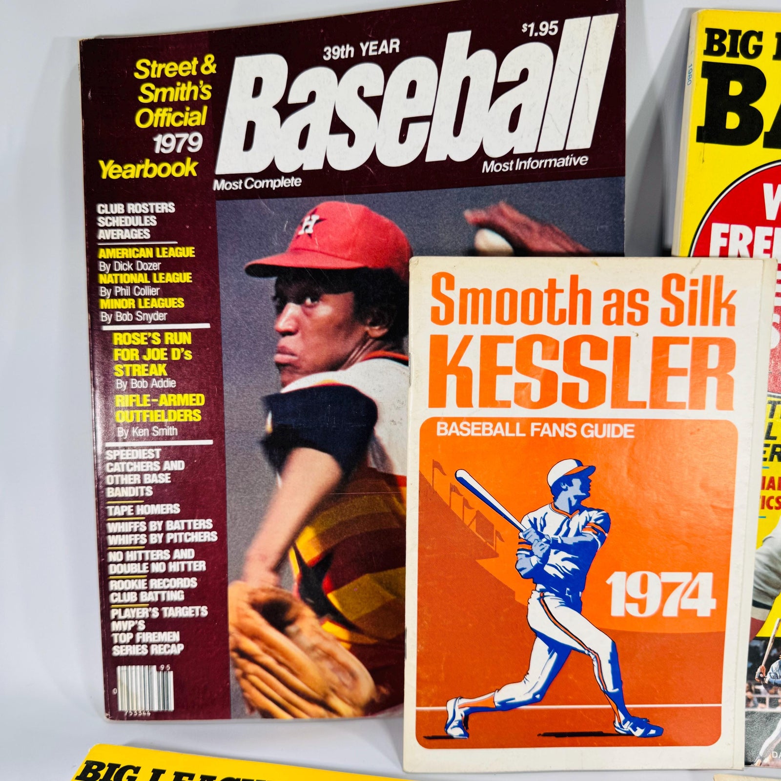 Assorted 1974–1980 baseball magazines and booklets arranged in a fan display, showing colorful covers and vintage MLB players.