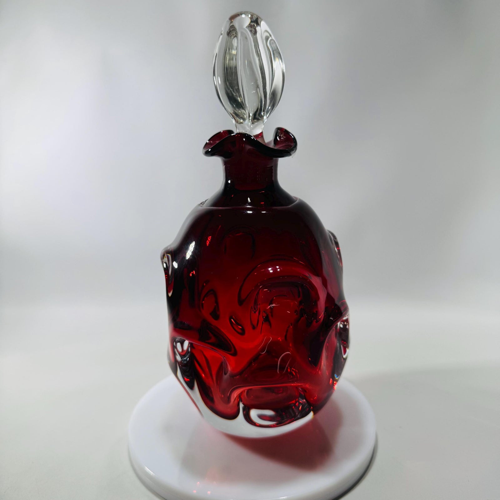 Ruby red Åseda art glass decanter by Bo Borgström with swirled “knobbly” body and clear teardrop stopper, Swedish mid-century.
