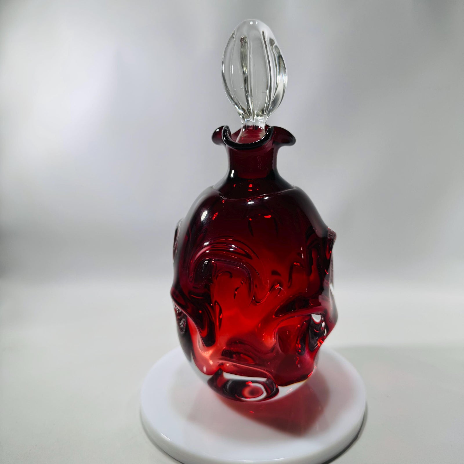 Ruby red Åseda art glass decanter by Bo Borgström with swirled “knobbly” body and clear teardrop stopper, Swedish mid-century.