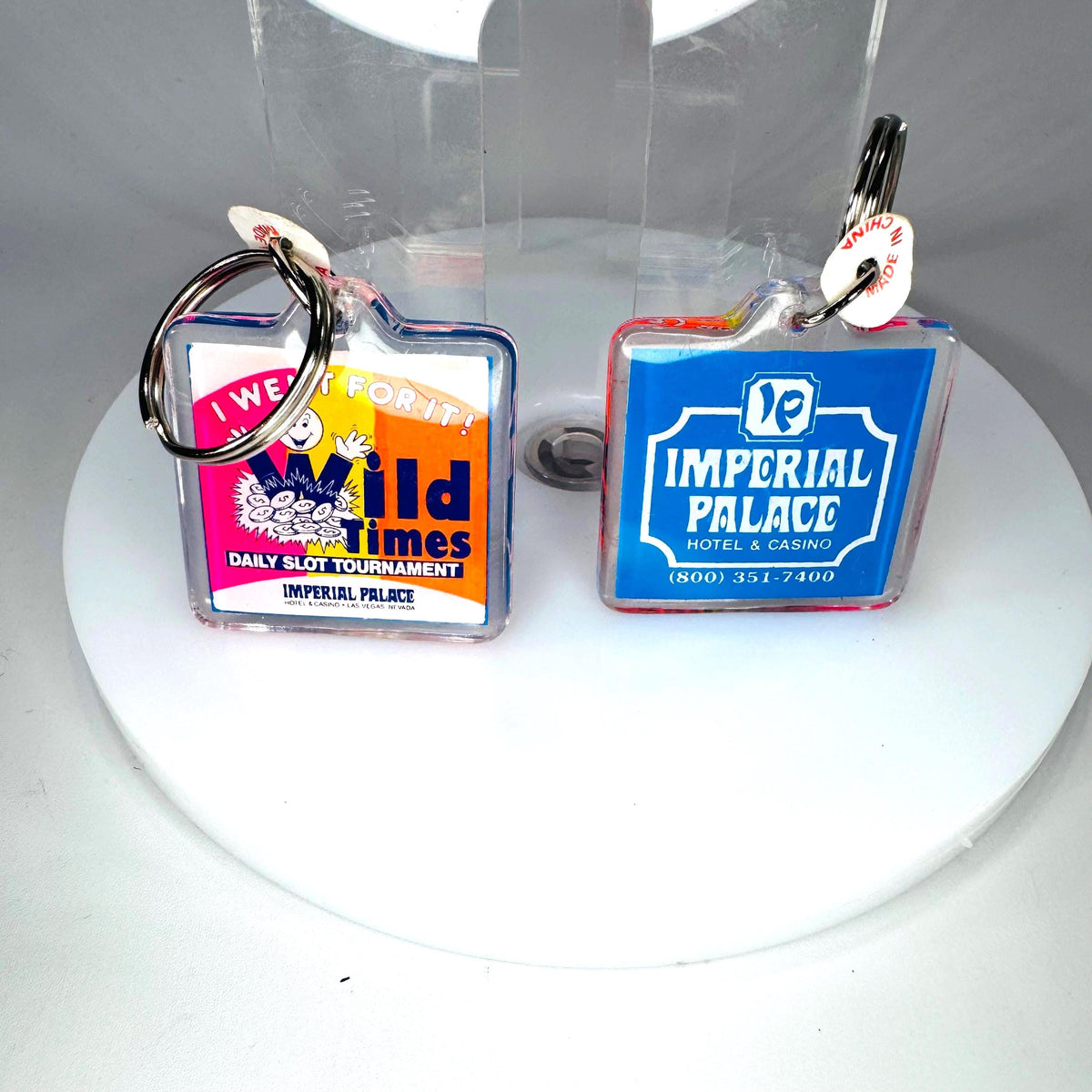 Matching vintage Imperial Palace Las Vegas casino keychains showing identical hotel logo and Old Times slot tournament designs