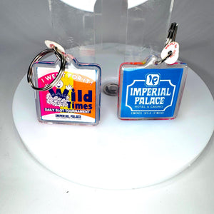 Matching vintage Imperial Palace Las Vegas casino keychains showing identical hotel logo and Old Times slot tournament designs