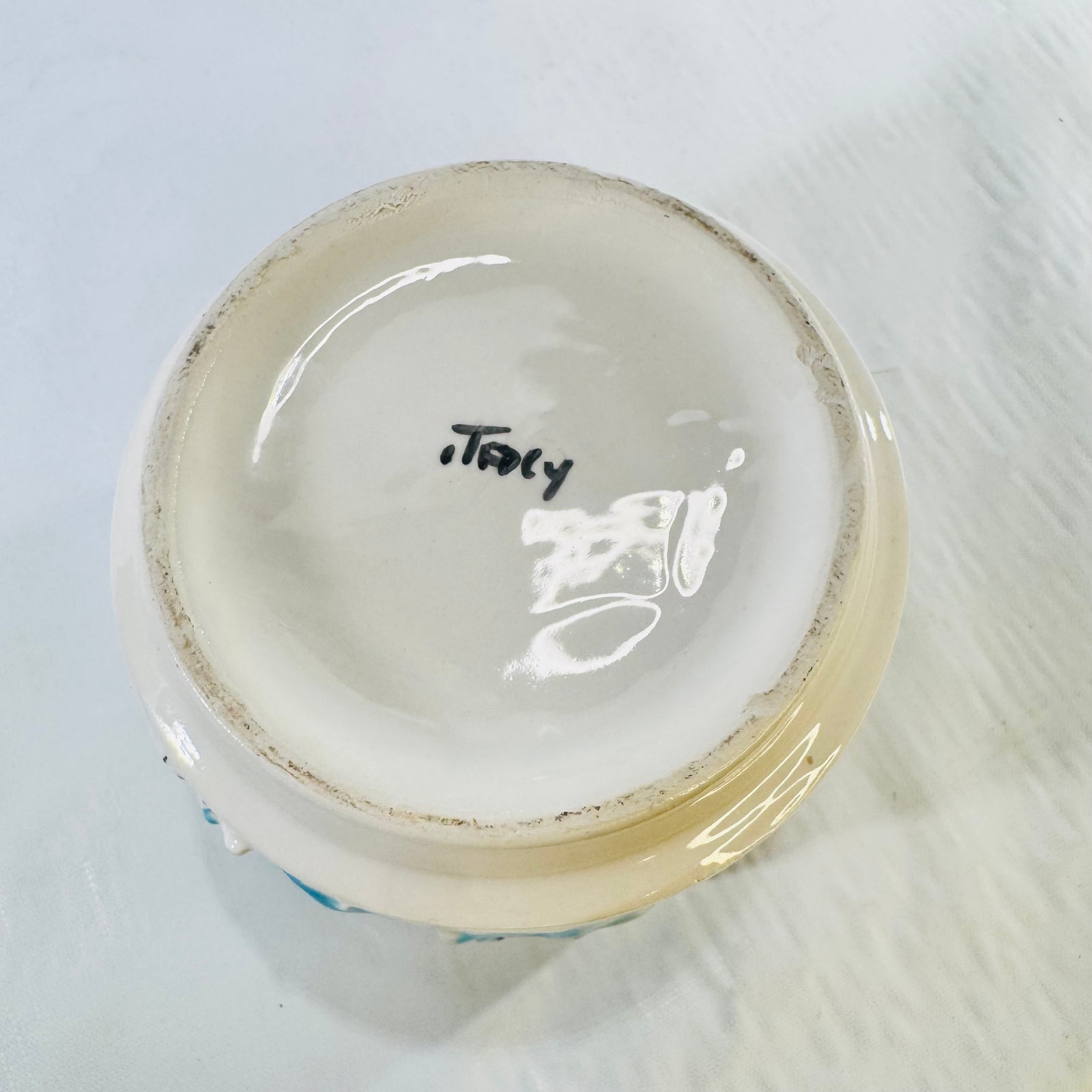 Underside of Italian pottery planter with handwritten Italy mark and worn foot ring