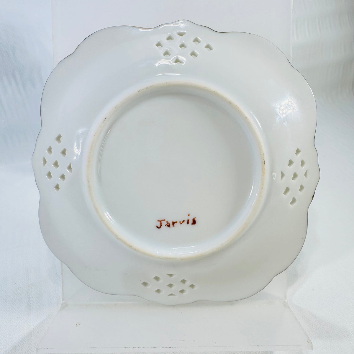 Back of the porcelain lattice dish showing the Jarvis signature and the foot ring.