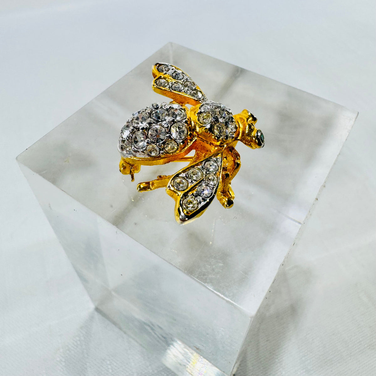 Side angle Joan Rivers bee brooch clear rhinestone wings and gold tone body