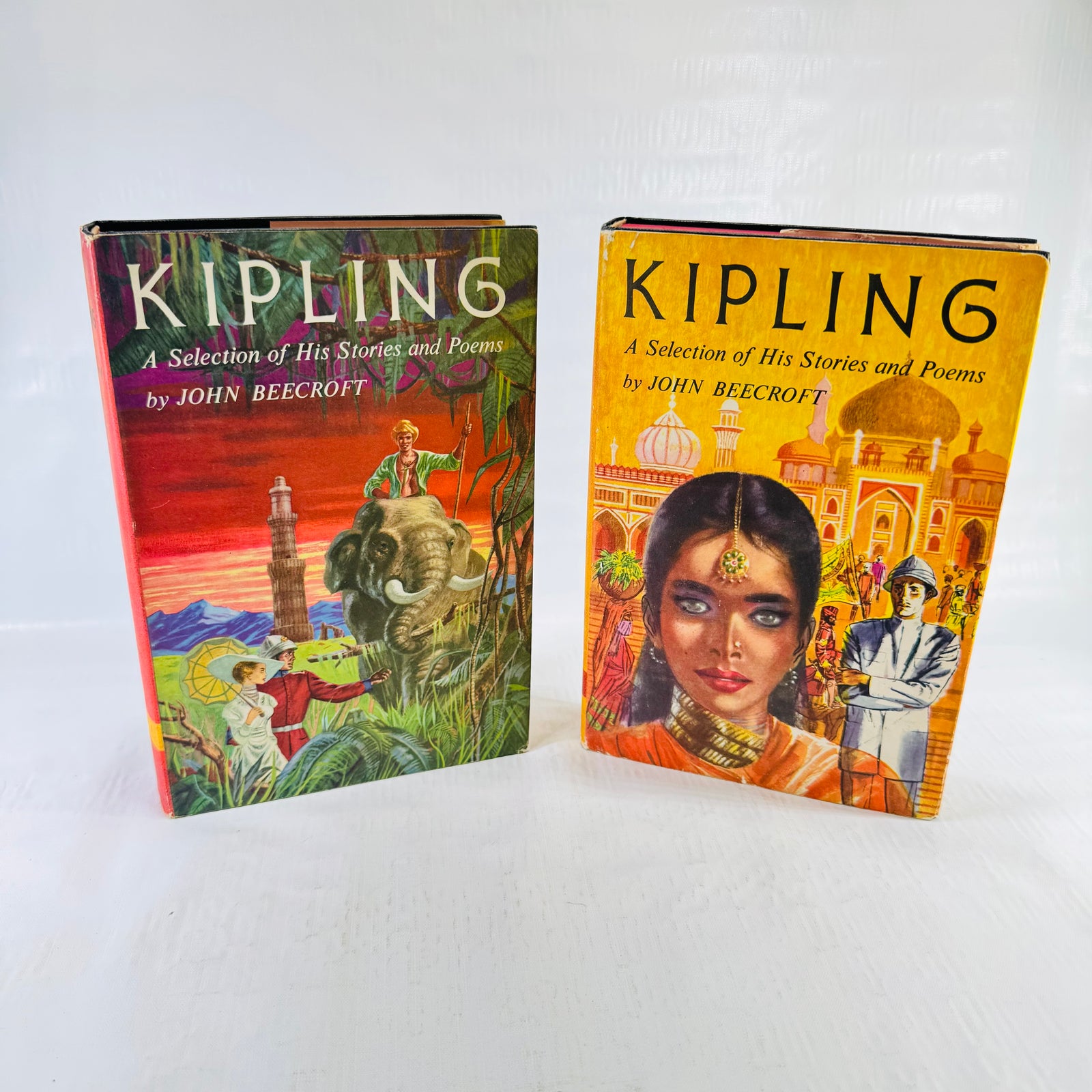 Both Kipling volumes in dust jackets, Volume I red jungle scene and Volume II yellow