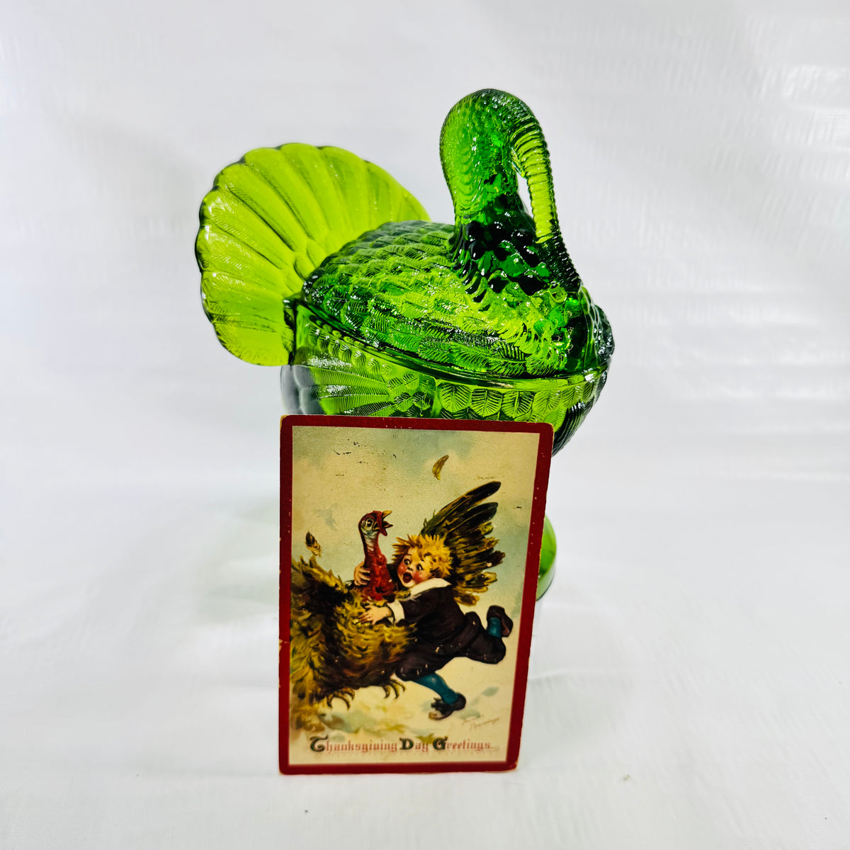 Green glass turkey covered dish with the Frances Brundage Thanksgiving postcard