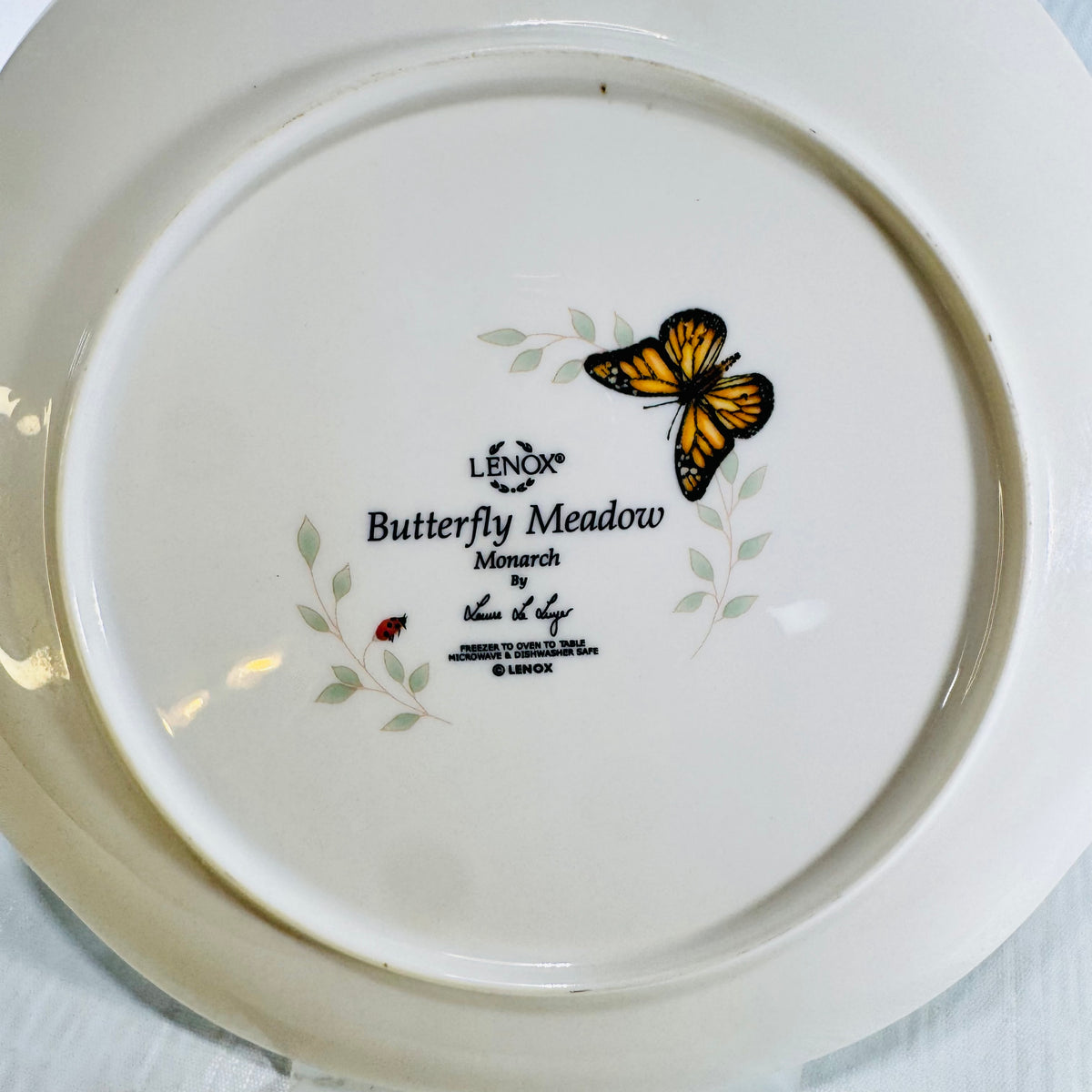 Close view of Lenox Butterfly Meadow Monarch backstamp with monarch butterfly art and ladybug
