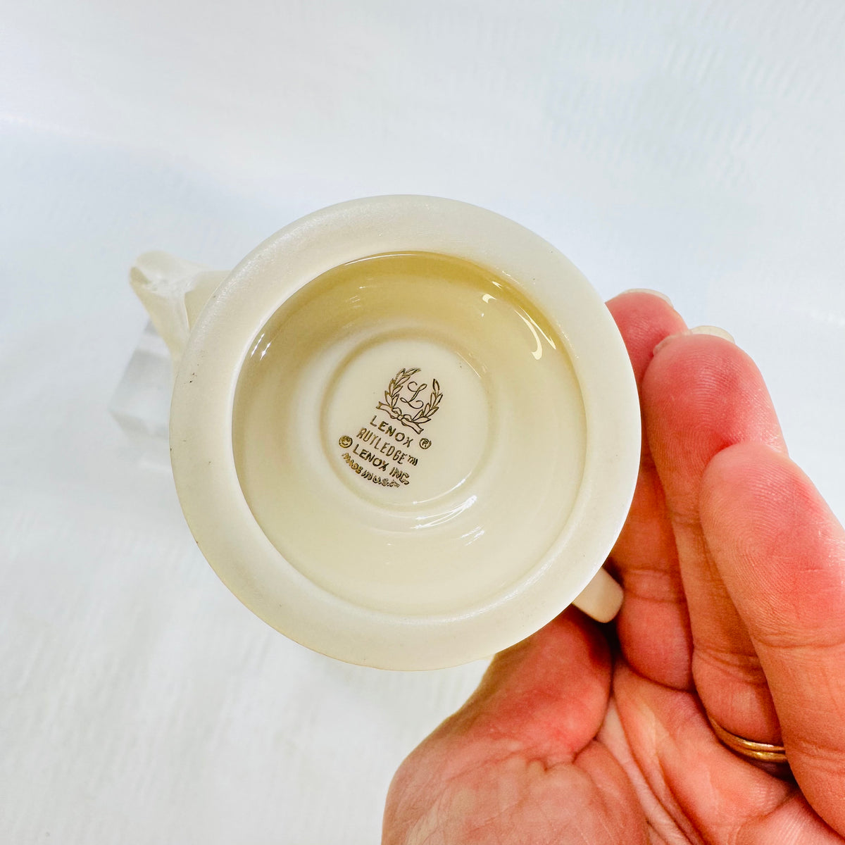 Underside of Lenox Rutledge creamer showing laurel wreath, pattern name and Made in USA