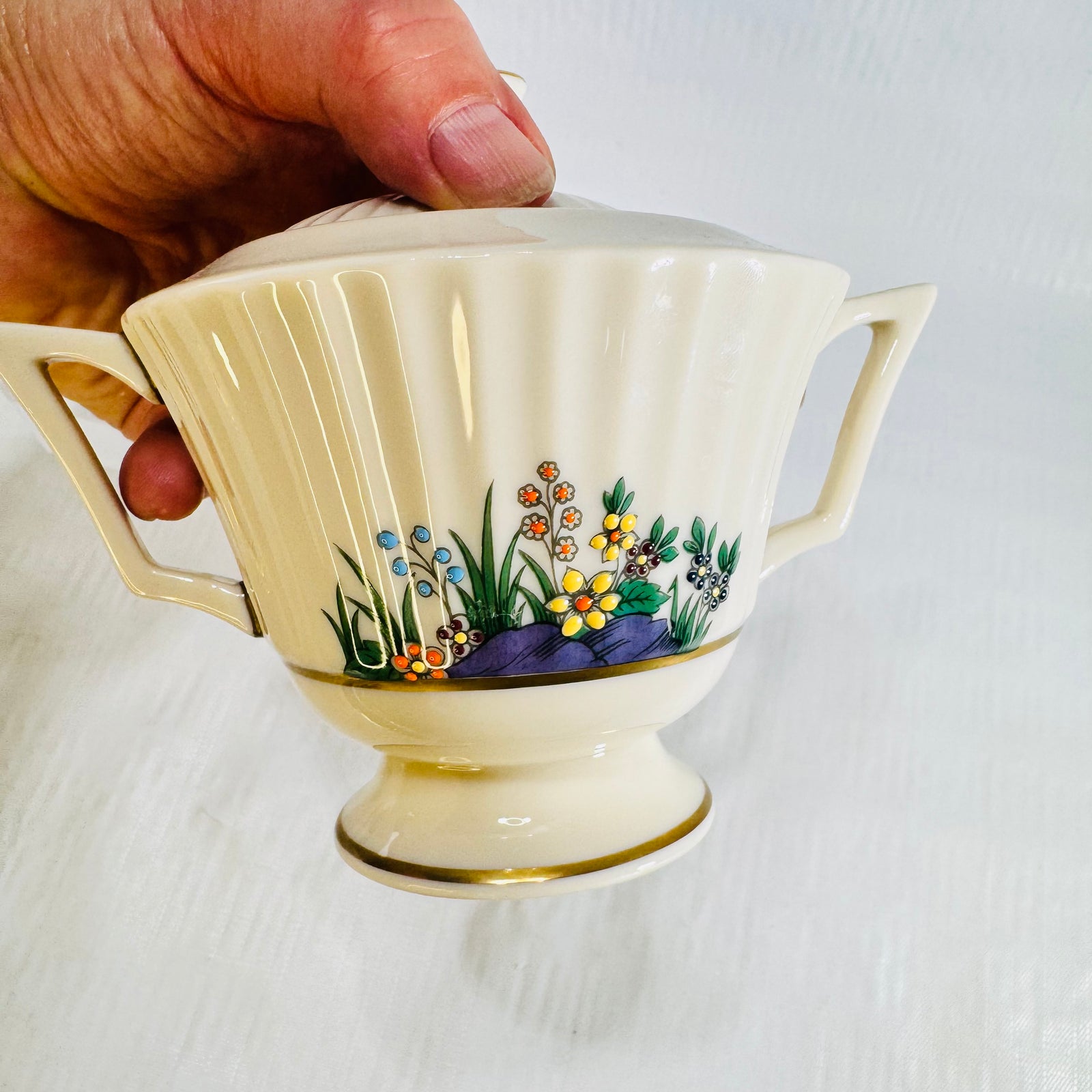 Lenox Rutledge covered sugar bowl with two handles, fluted body, gold bands and floral spray