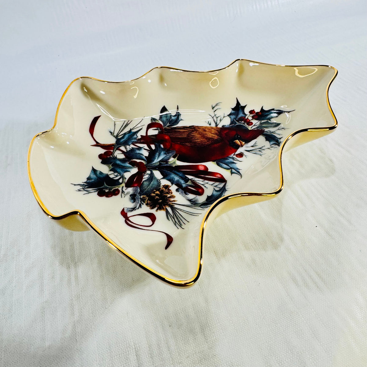 Angled view of Lenox Winter Greetings cardinal porcelain tree shaped candy dish