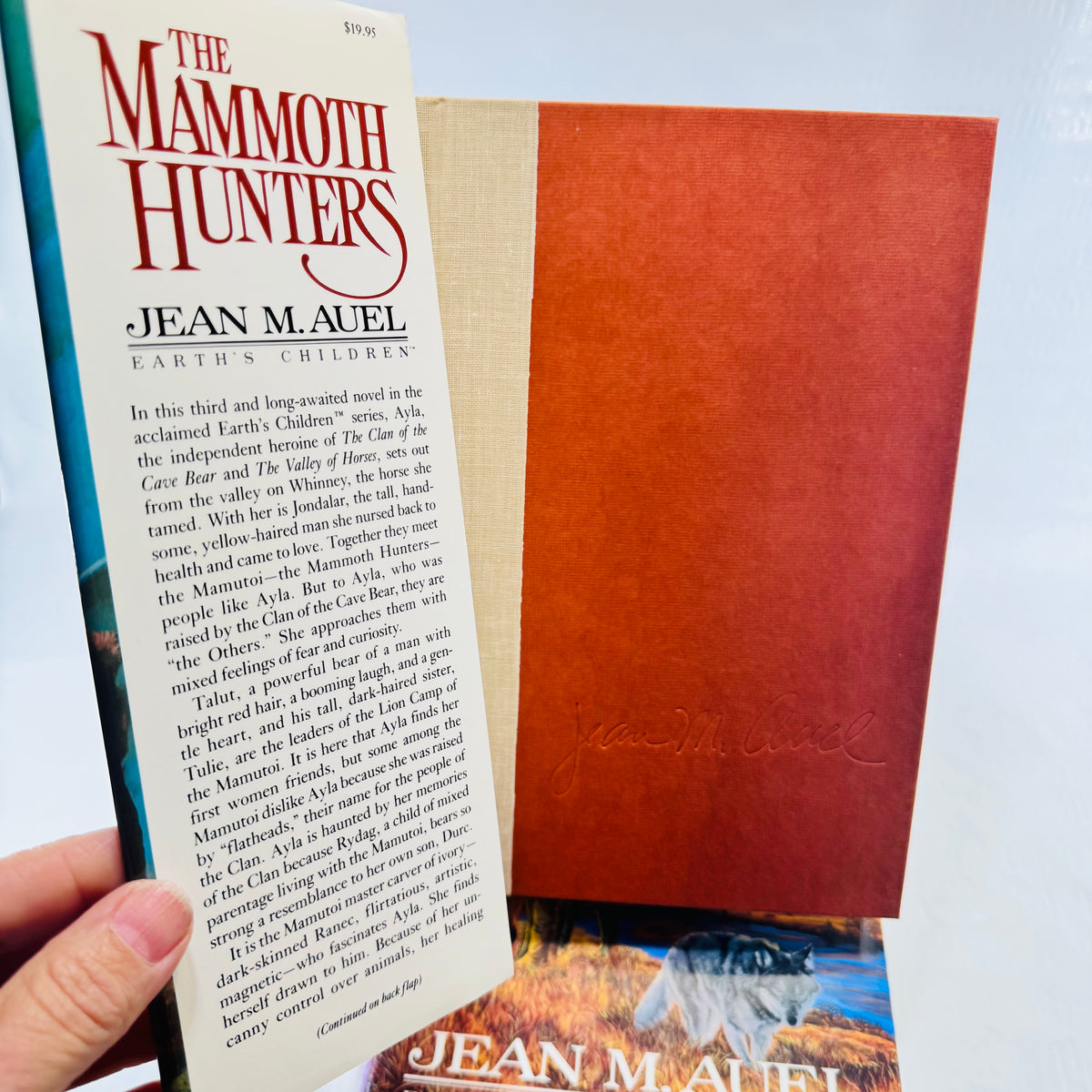 Mammoth Hunters jacket flap showing 19.95 price above brown boards and a printed facsimile signature