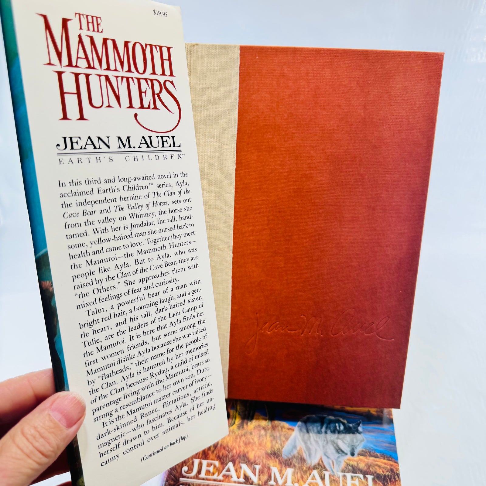 Mammoth Hunters jacket flap showing 19.95 price above brown boards and a printed facsimile signature