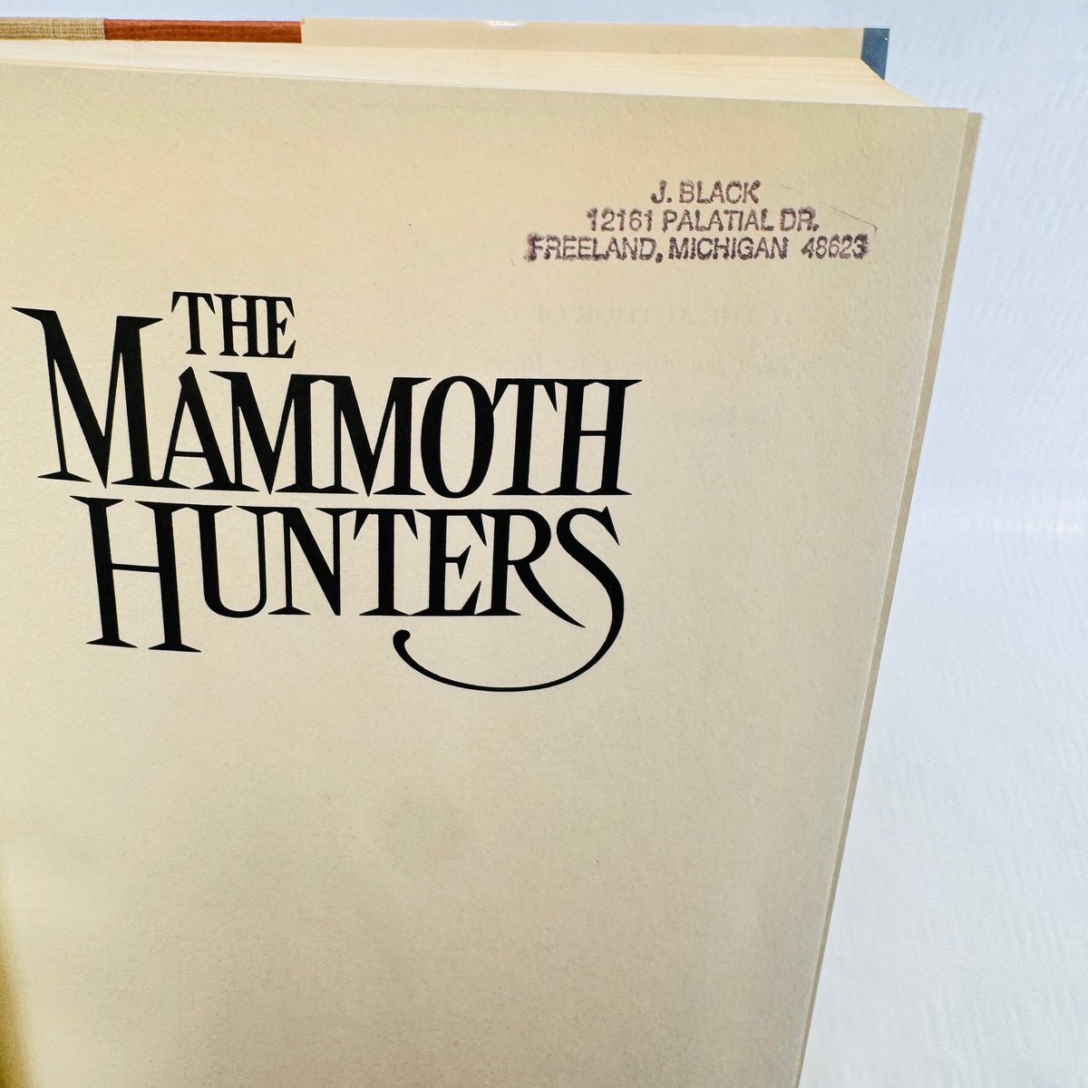 Mammoth Hunters title page carrying a purple ink Michigan address stamp