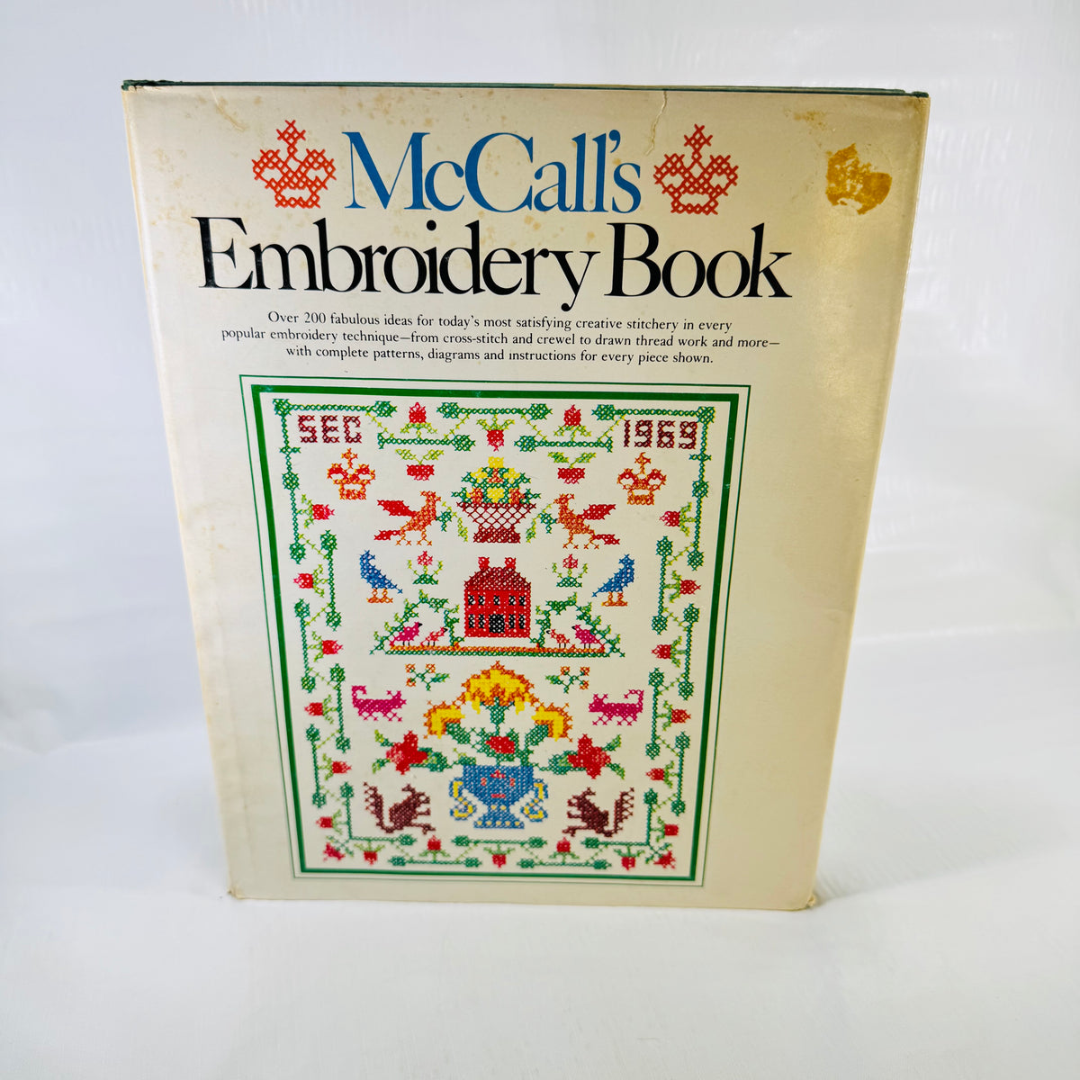 McCall's Embroidery Book 1976 front dust jacket with cross stitch sampler cover