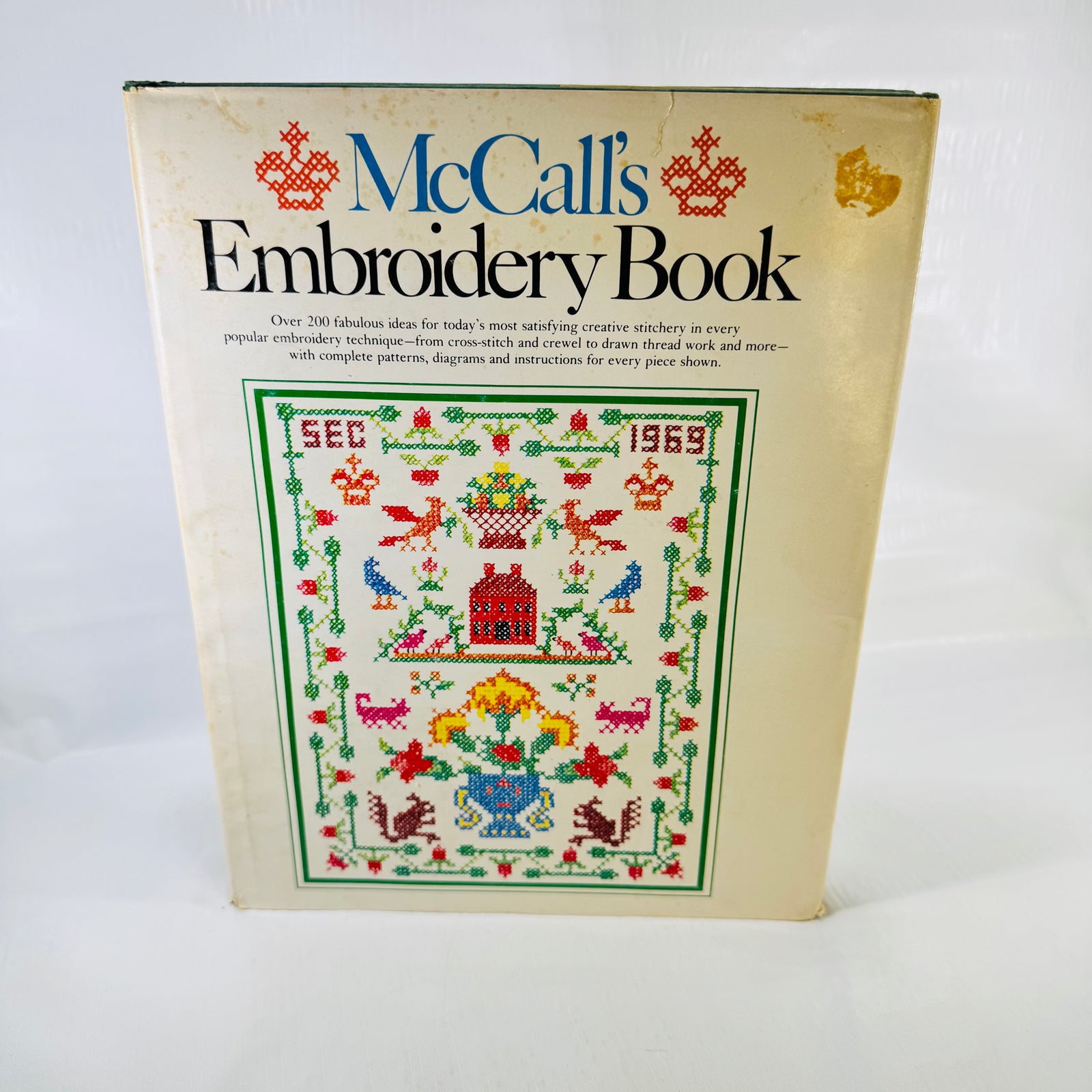 McCall's Embroidery Book 1976 front dust jacket with cross stitch sampler cover