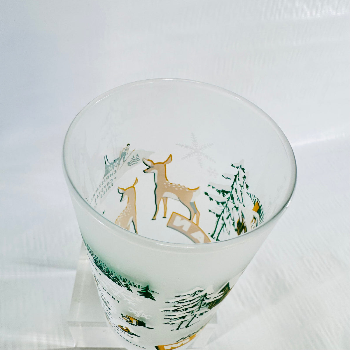 High angle view into the rim of the frosted tumbler showing the fawns and snowflakes.
