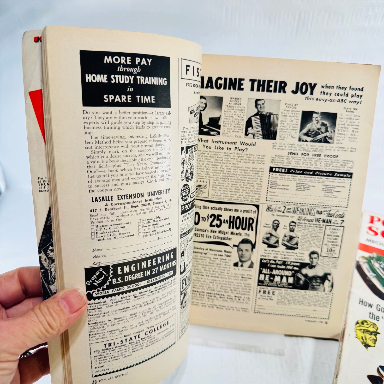 February 1951 Popular Science pages 40 and 41 with LaSalle, music school and Charles Atlas ads
