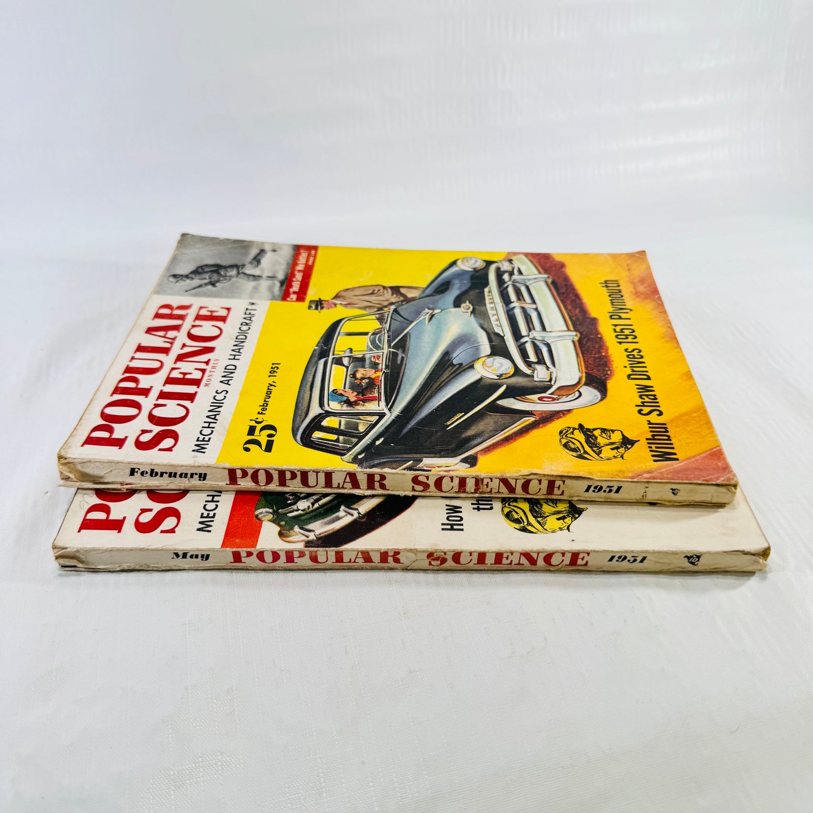 Stacked 1951 Popular Science issues showing February and May dates on both spines