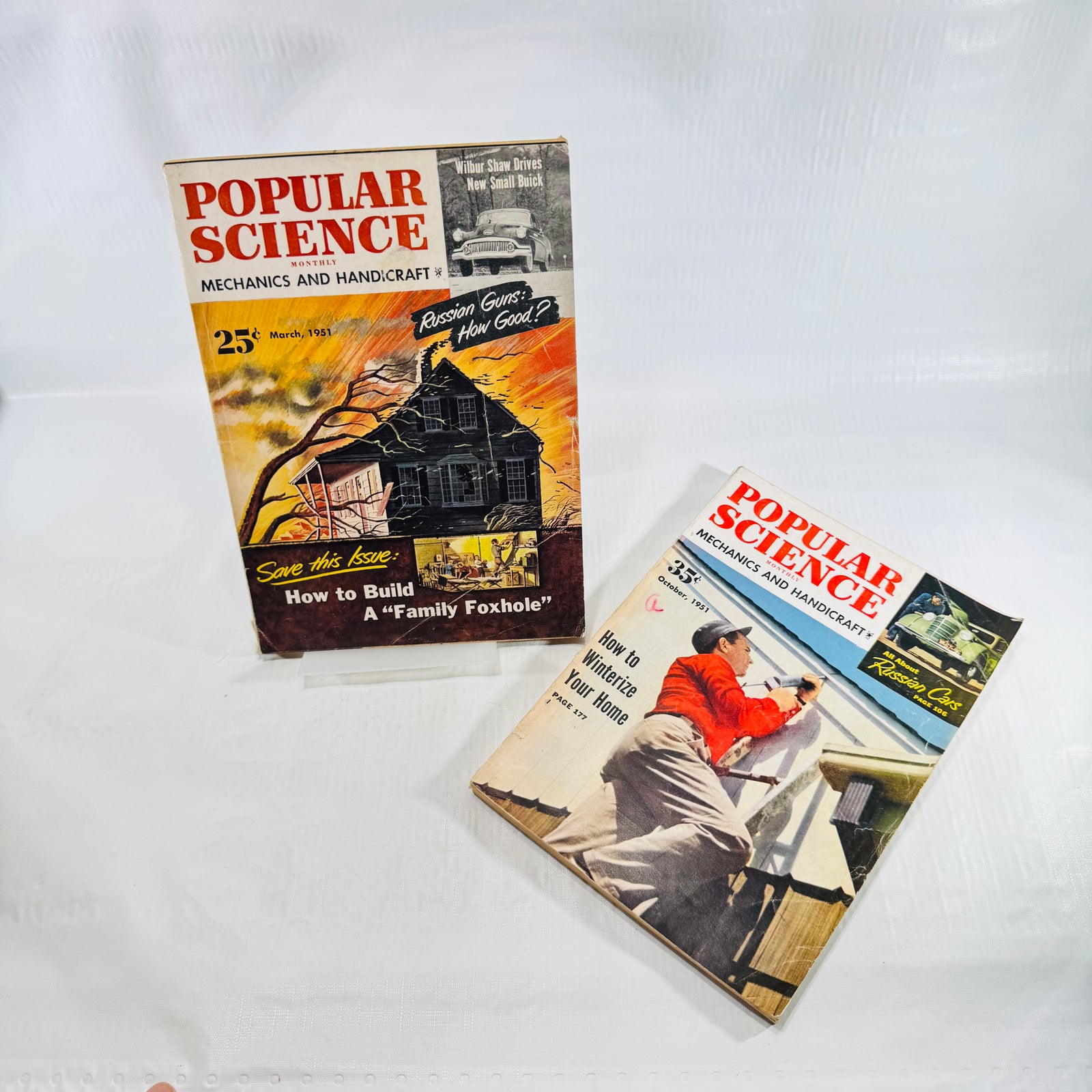 March and October 1951 Popular Science Monthly covers on stands, Family Foxhole and winterize home issues