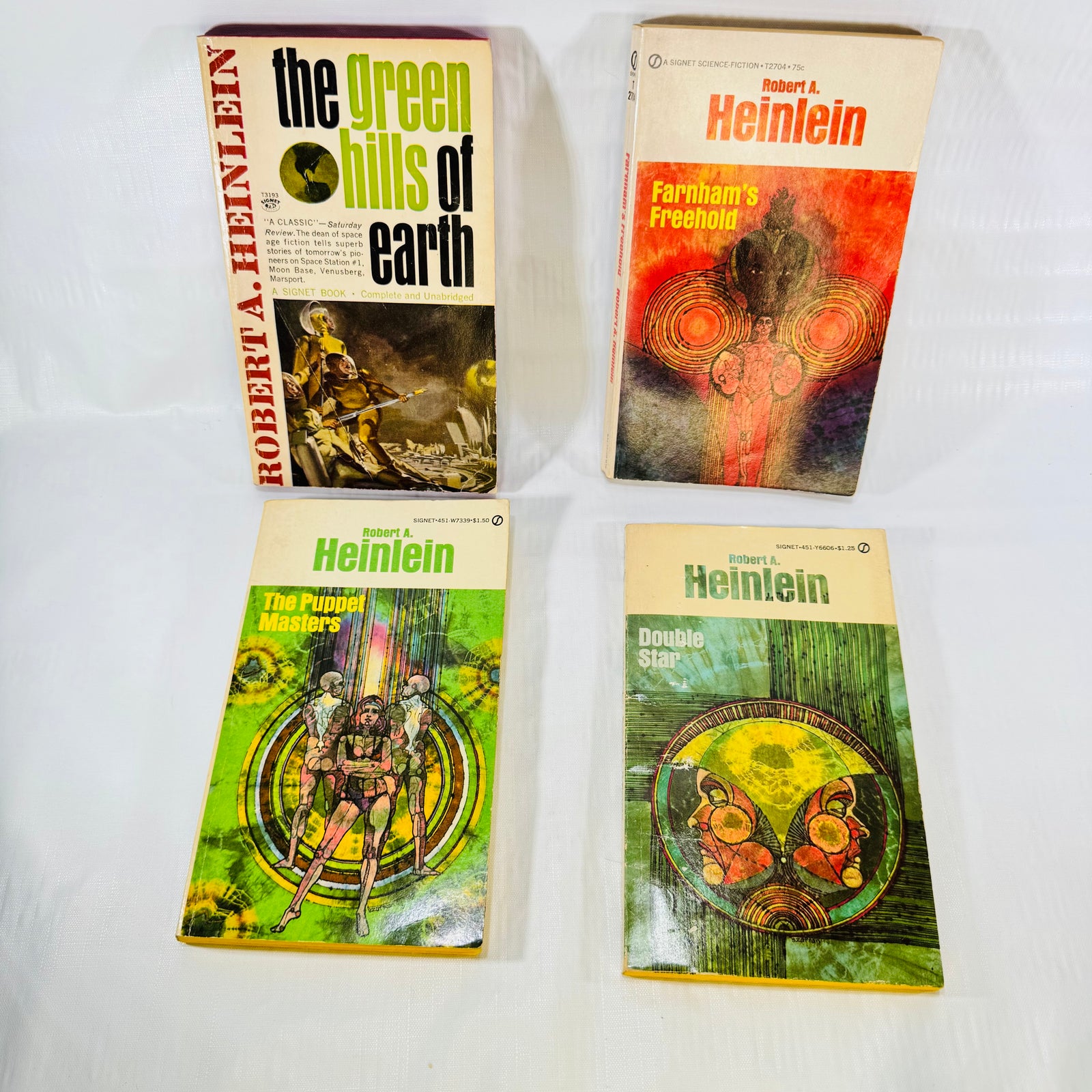 Four vintage Robert A. Heinlein Signet paperbacks, front covers