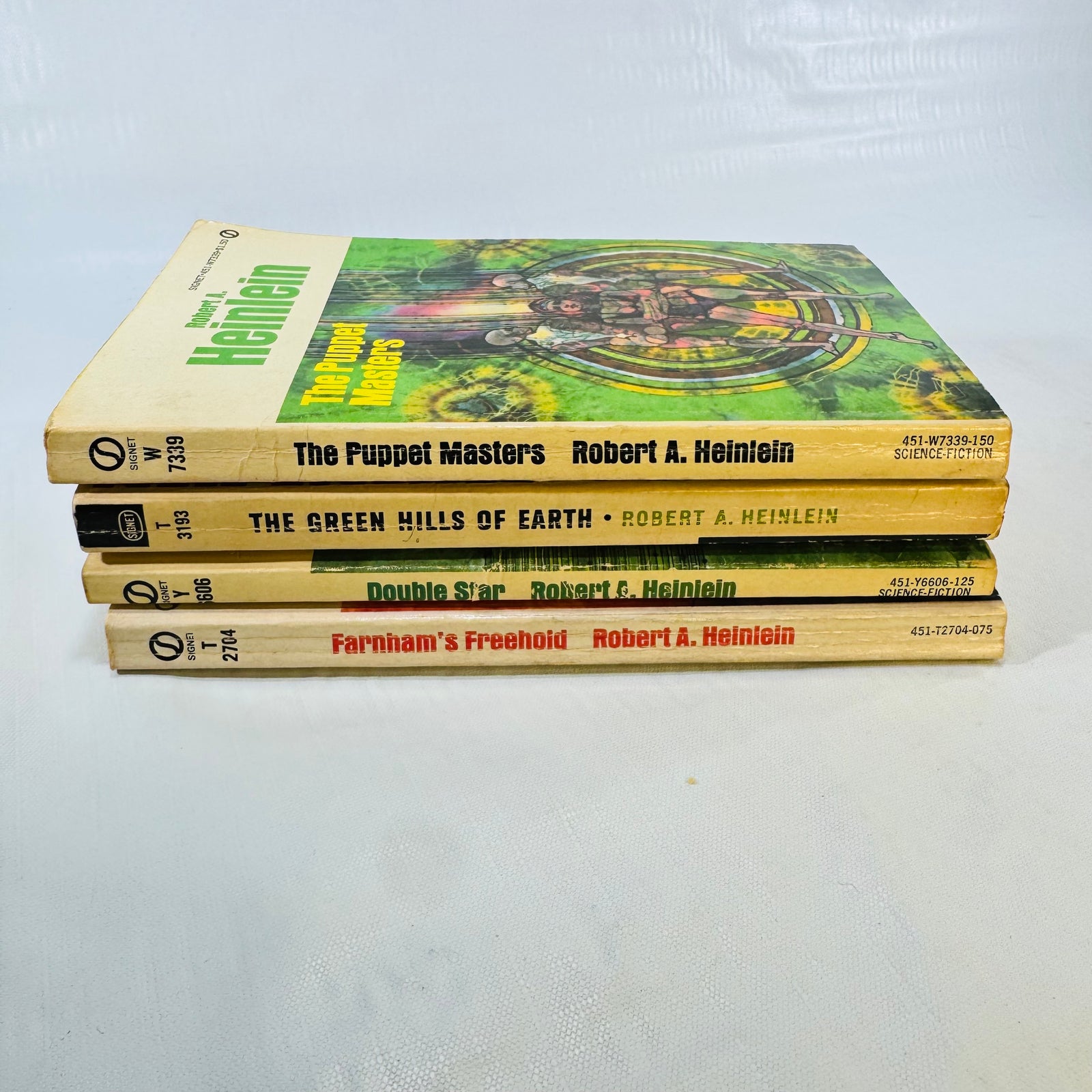 Spines of four vintage Heinlein Signet paperbacks