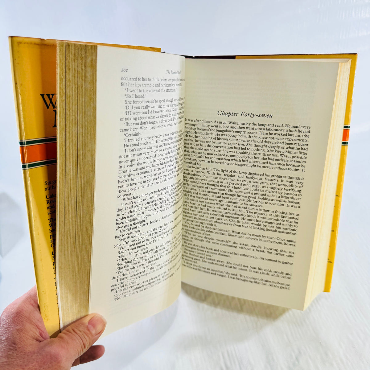 Open pages showing The Painted Veil text and binding